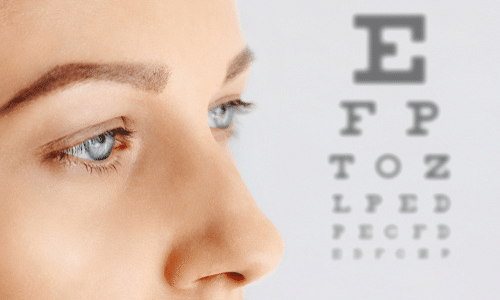 Woman with eye exam chart behind her