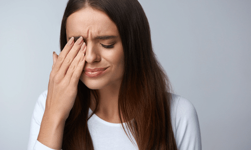 Woman experiencing eye pain
