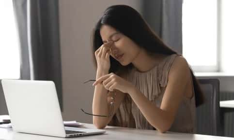 A woman experiencing eye strain